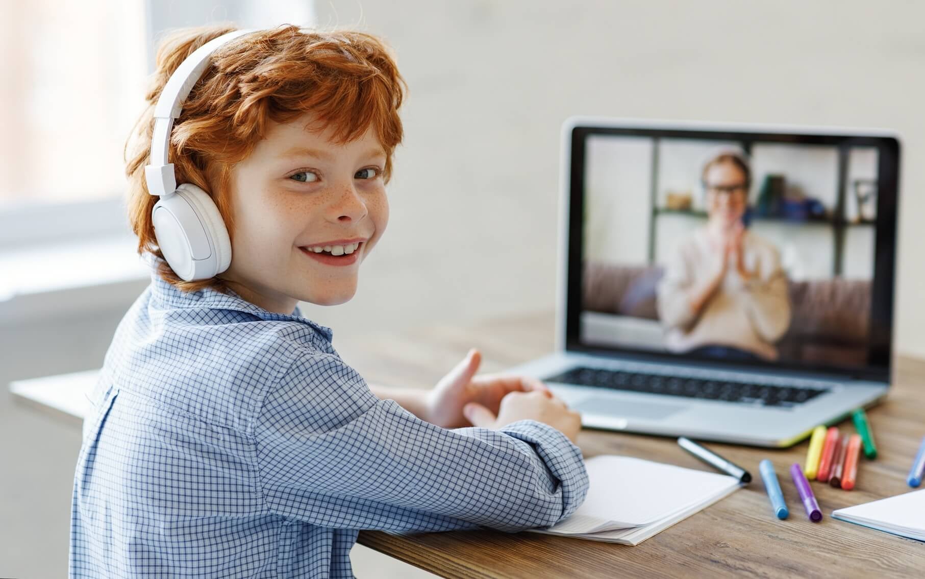 Cheerful boy during online lesson at home.